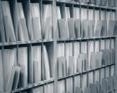 Letters lined up in a mailroom stamped by a postage meter