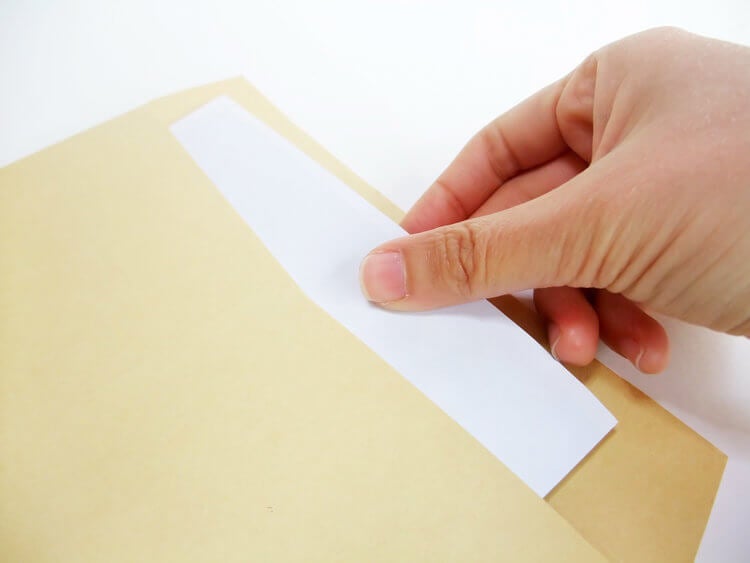 Pulling a piece of paper out of an envelope