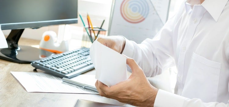 Office worker opening an envelope