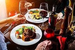Restaurant customers with food and wine