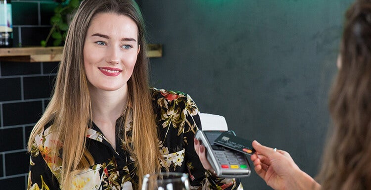 Woman paying using a card reader