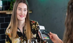 Woman paying using a card reader