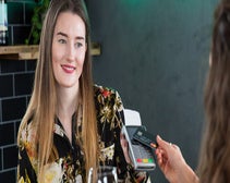 Woman paying using a card reader