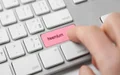 Person pressing button on keyboard that reads 'freemium'