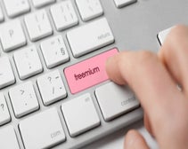 Person pressing button on keyboard that reads 'freemium'