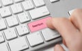 Person pressing button on keyboard that reads 'freemium'